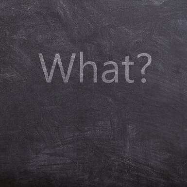 The word what with question mark written on blackboard