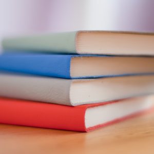 A stack of books such as those that the library can offer as resources