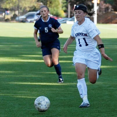 Laurie Boland (right) playing collegiate socce