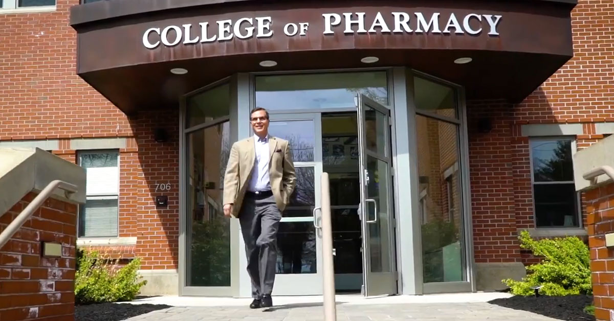Dan Mickool stepping out of the College of Pharmacy building