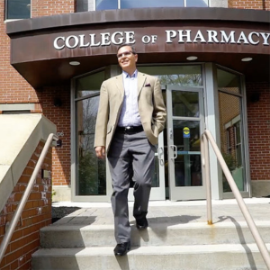 Dan Mickool stepping out of the College of Pharmacy building