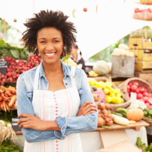 Woman standing in front of barrels of fruit to celebrate National Nutrition Month 2019®