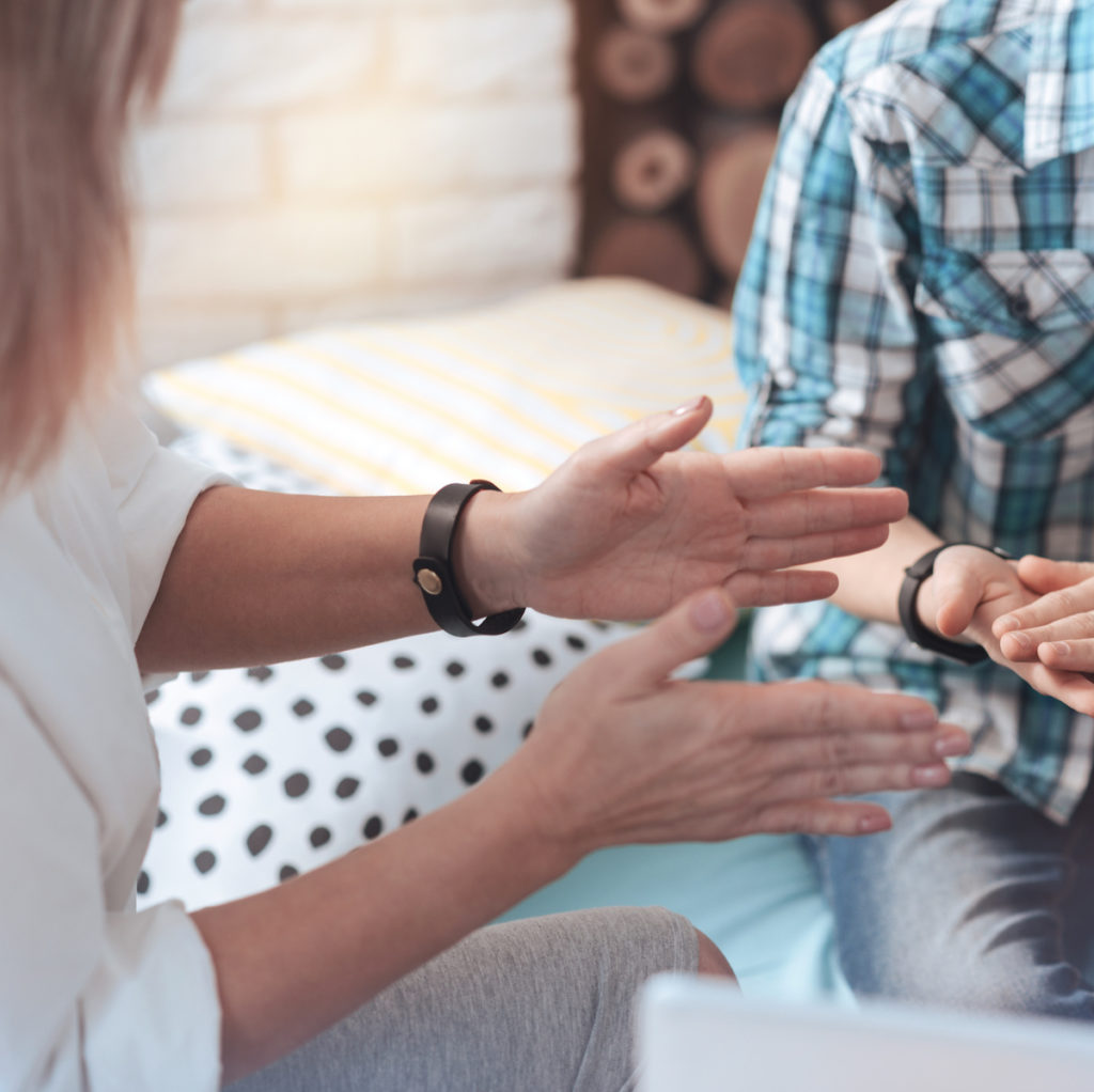 A school social worker in her role gesturing to a student to assist him with his issue