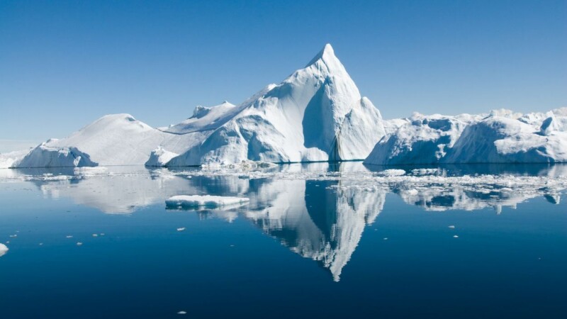 Icebergs drift in calm seas off the Greenland coast.