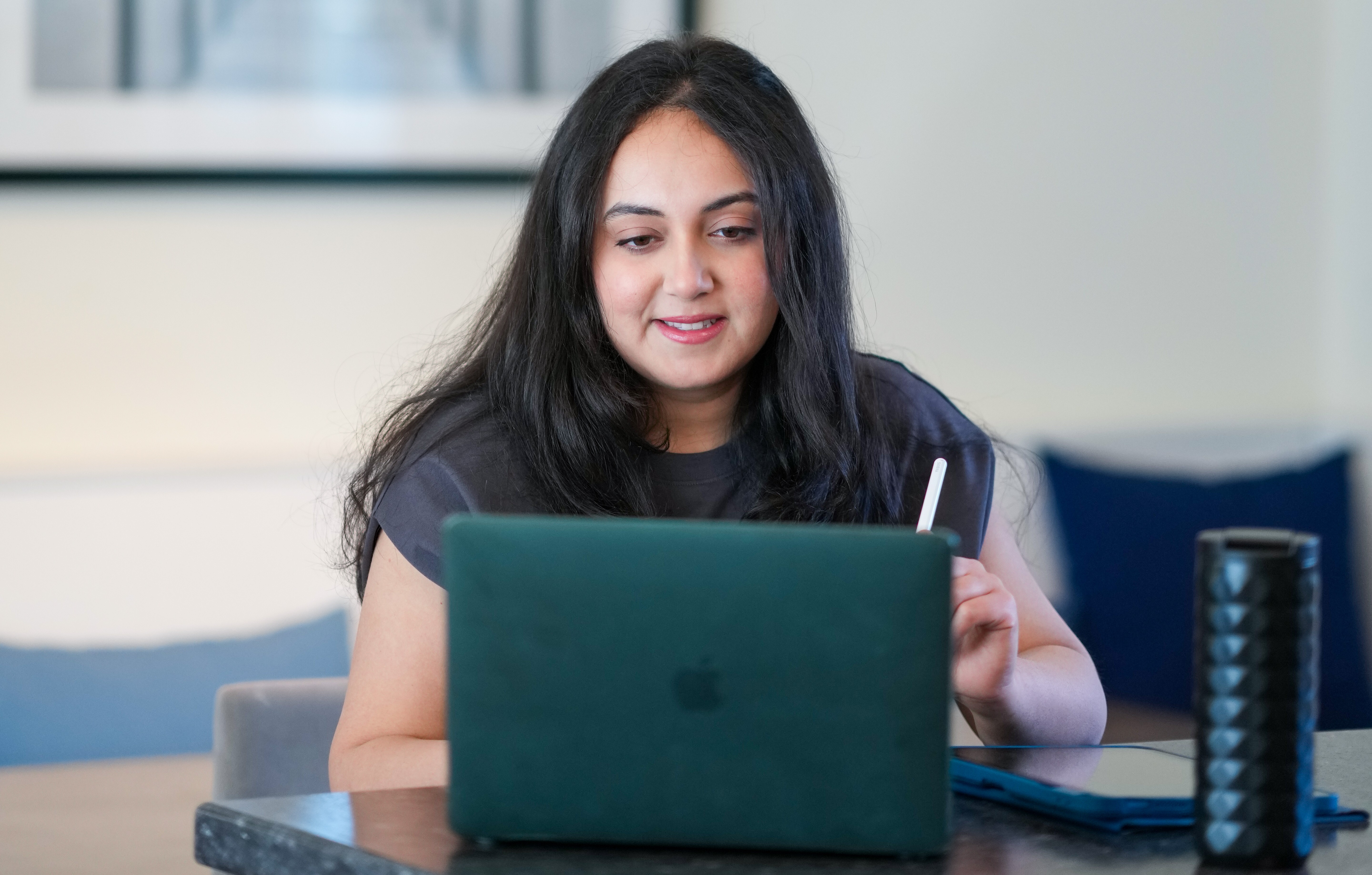 Student working on her laptop at the kitchen table
