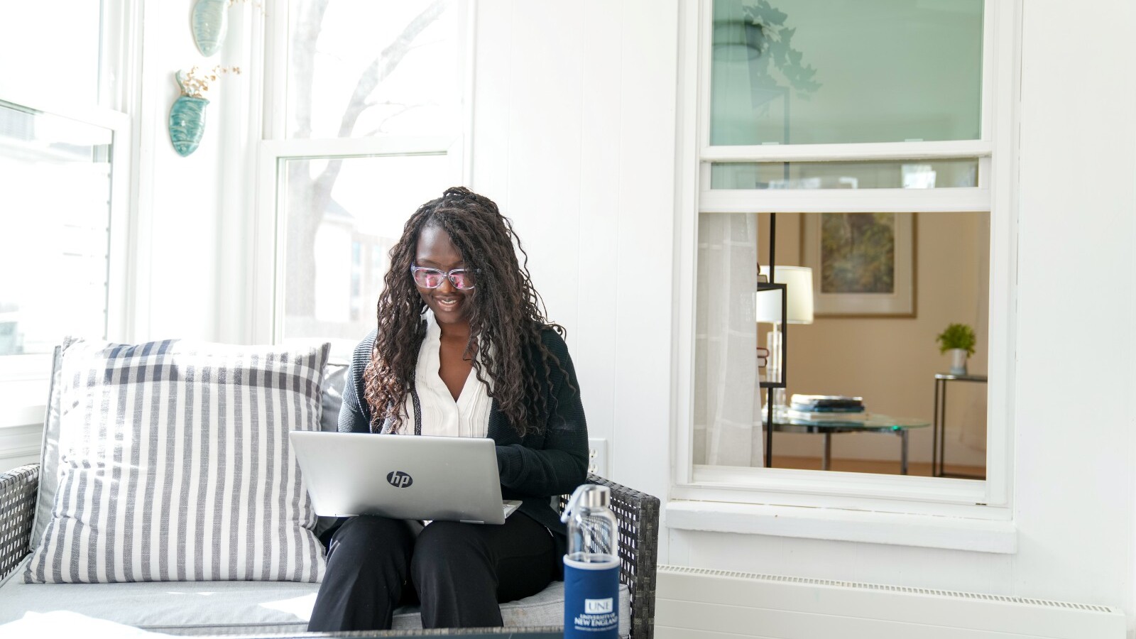Student on a couch using a laptop