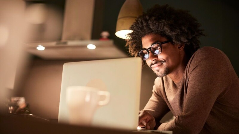 Student working on a laptop late at night