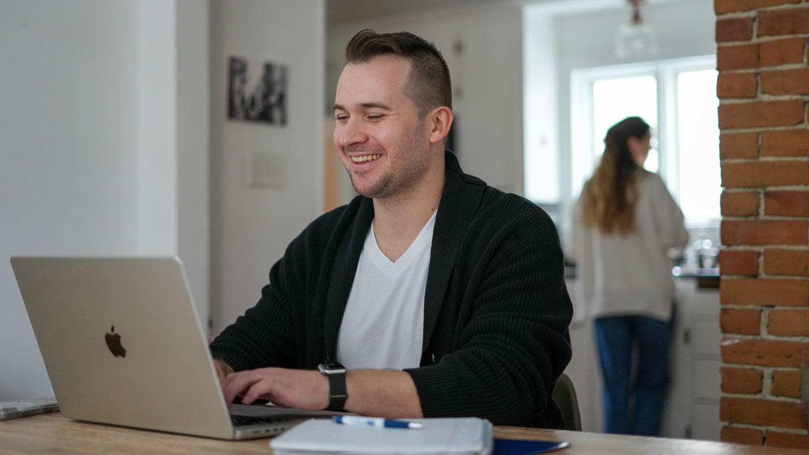Student sitting at a table working on a laptop