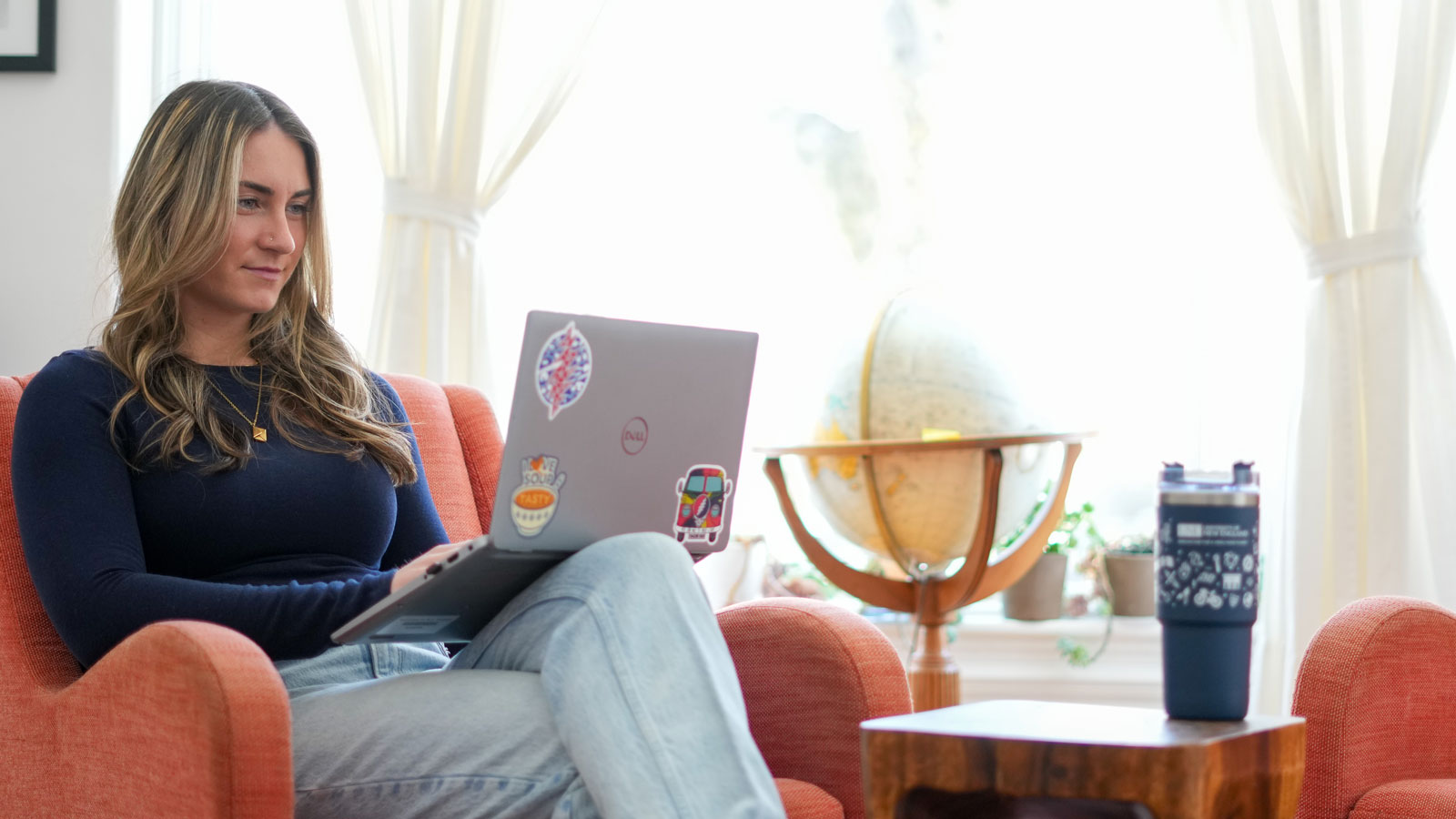 Adult student sitting in a chair using a laptop