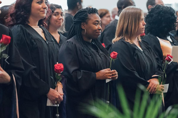 At the Masters level, regalia consists of a simple black gown.  What distinguishes a Masters level gown from a Baccalaureate gown is the sleeves.  Masters level gowns usually have long, extended sleeves.  Historically, those sleeves could have been used as pockets.