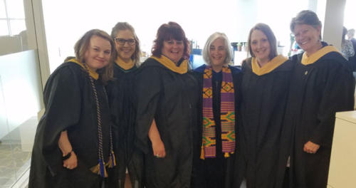 A few of our Social Work faculty show off their citron-colored hoods.